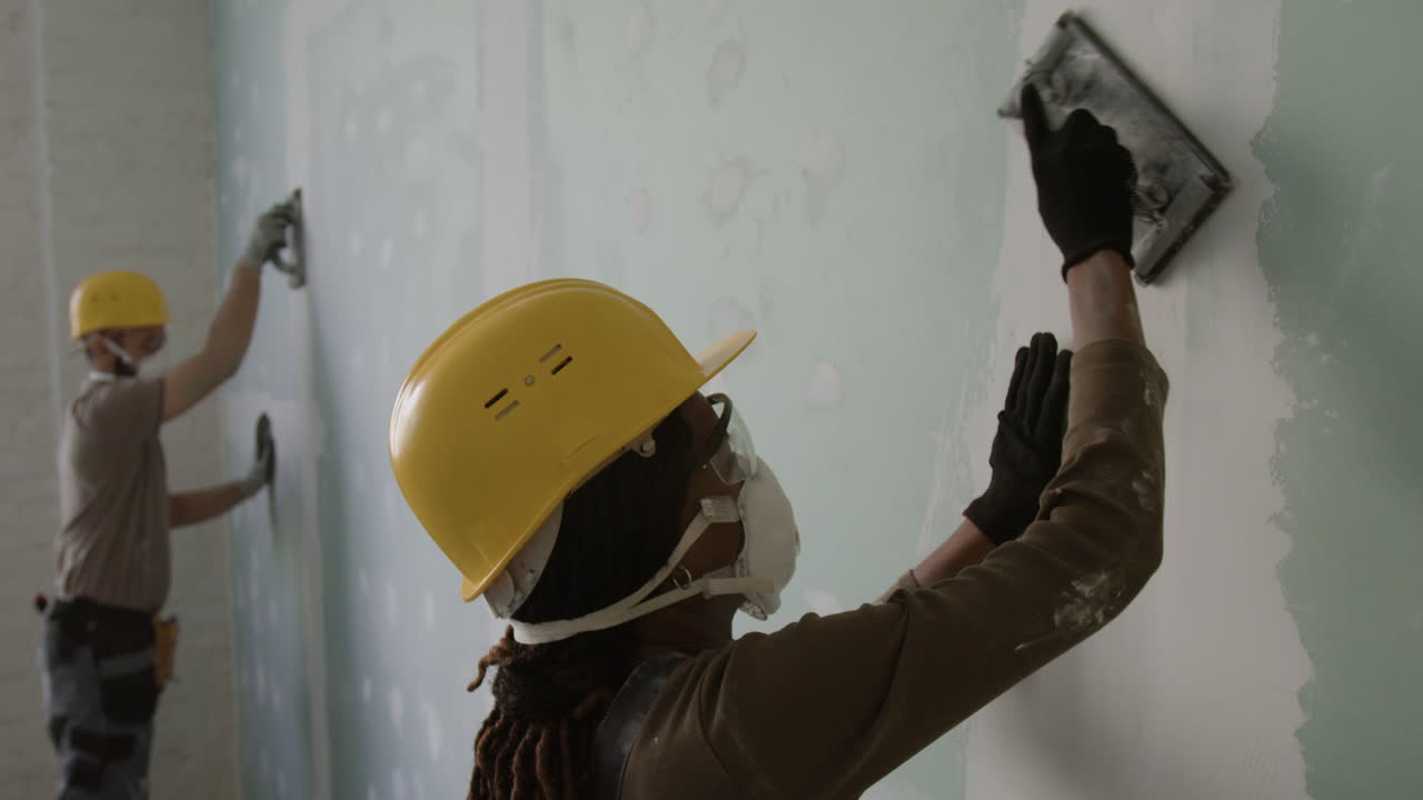Construction workers renovating a wall