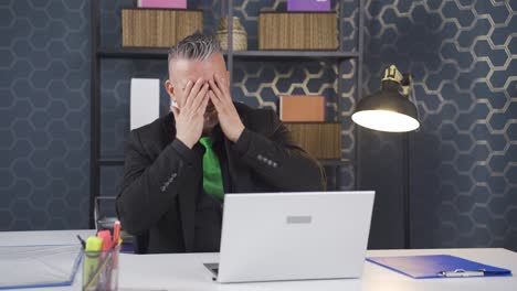 businessman looking scared at laptop.