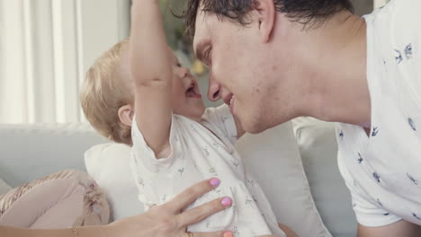 toddler playing with hair of dad