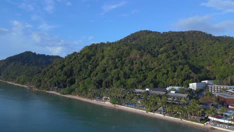 Lovely-aerial-top-view-flight-Beach-Village-Huts-Resort,-tropical-Bungalows-on-Mountainous-Island-Thailand-2022