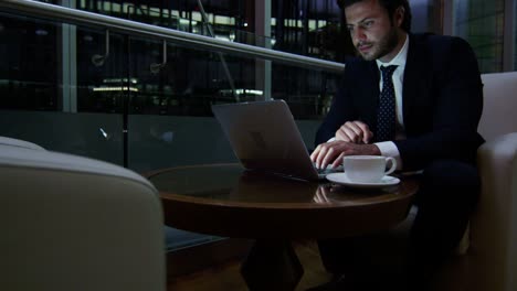 arabic businessman hotel atrium night using laptop computer