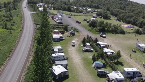 camping site hallormsstaður in east iceland on sunny day, parked vehicles, aerial