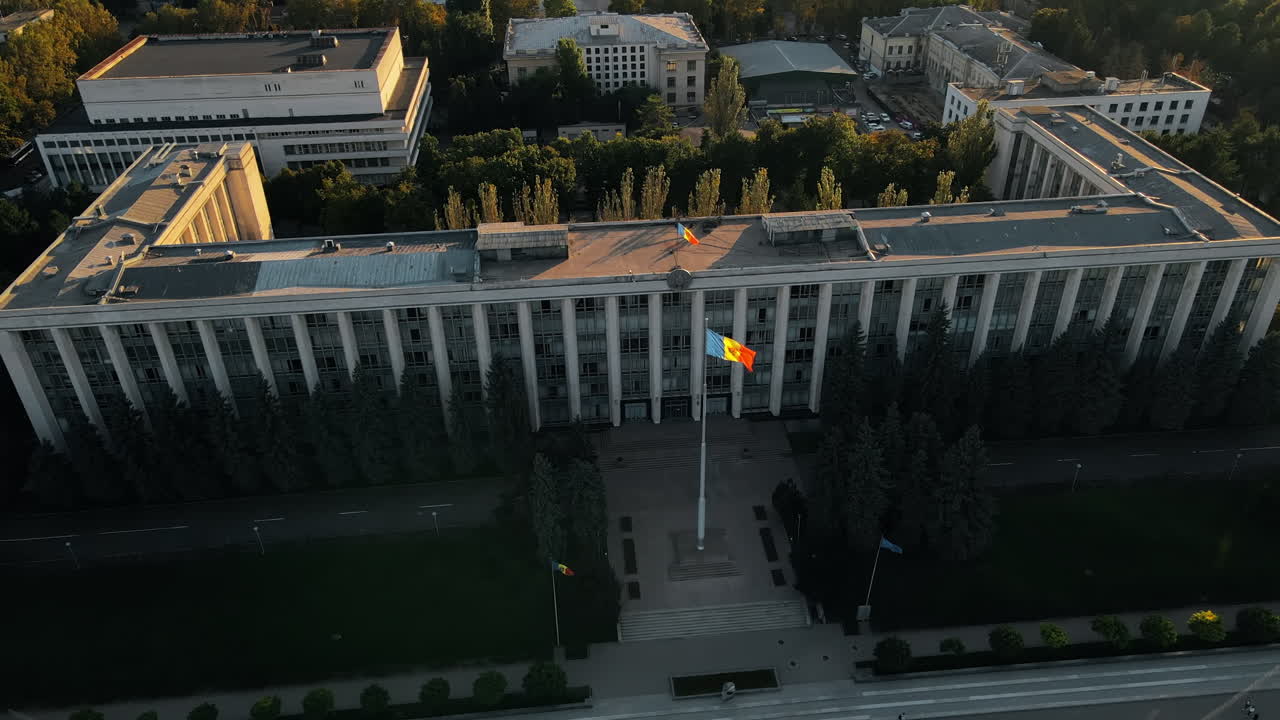 Aerial drone view of Chisinau downtown at sunset. View of Goverment building, road with walking people. Moldova