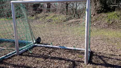 slow motion panning up from miniature soccer goal in germany on sunny winter day