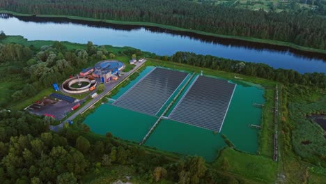 Eco facility with dual circular tanks - floating solar fields, Lielupe River