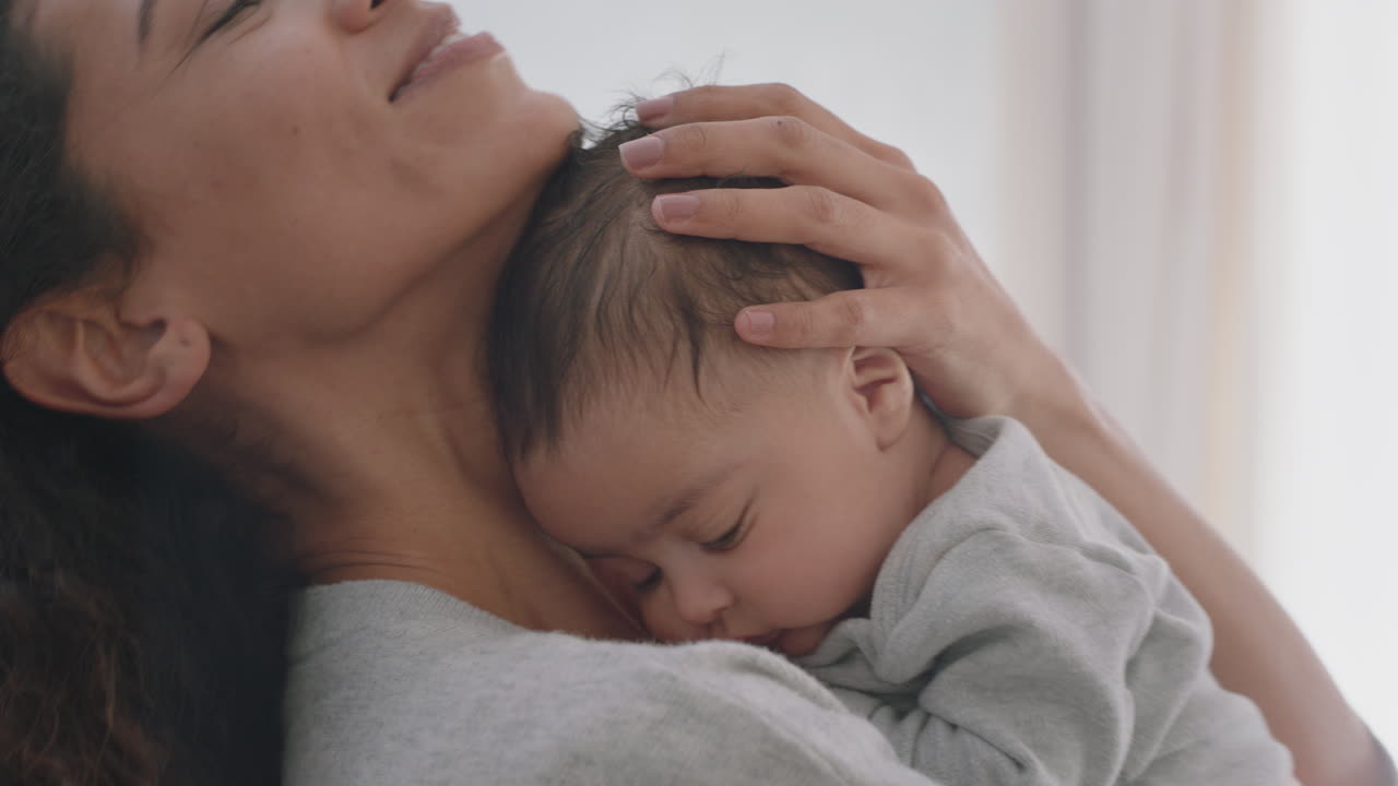 Mother holding baby calming tired newborn gently soothing restless ...