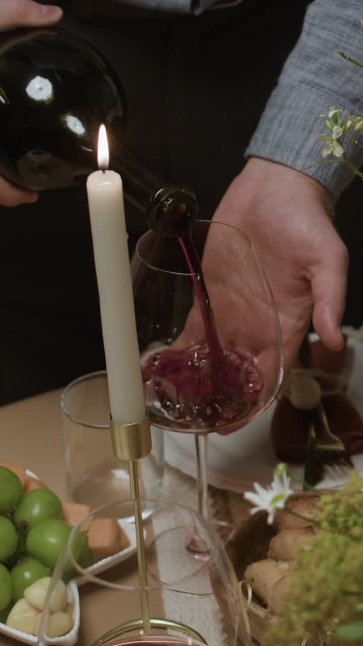 Pouring wine at dinner party