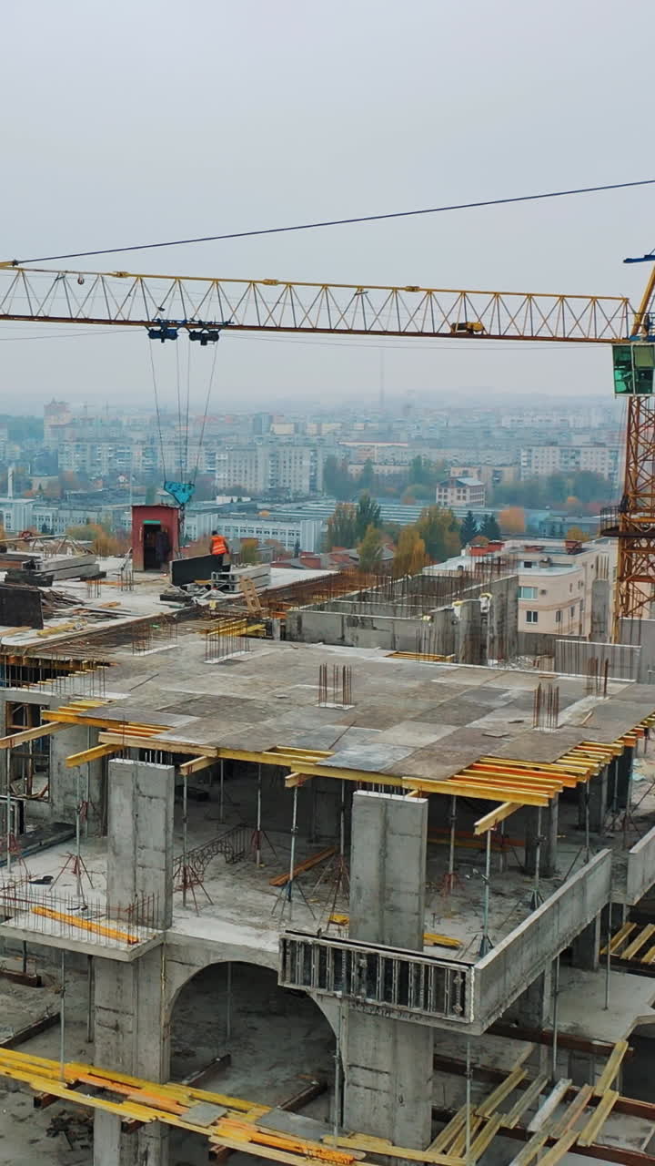 Construction of a residential apartment complex. Aerial view. Vertical video