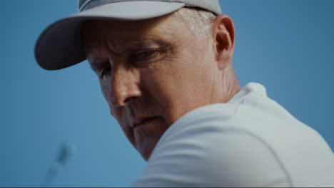 Senior-face-looking-golf-ball-on-sunny-blue-sky.-Old-man-play-sport-game-outside