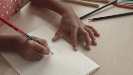 unrecognizable child learning drawing