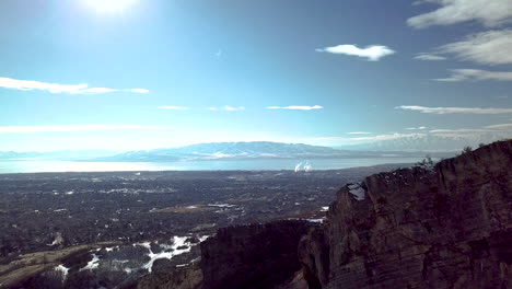 Looking-over-a-cliff-at-a-city-and-factory-in-the-valley-below-on-a-winter-day