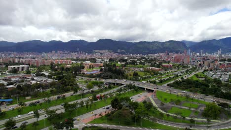 Journey-above-the-vibrant-streets-of-Bogotá,-Colombia,-as-our-drone-takes-flight-over-the-bustling-26th-Street