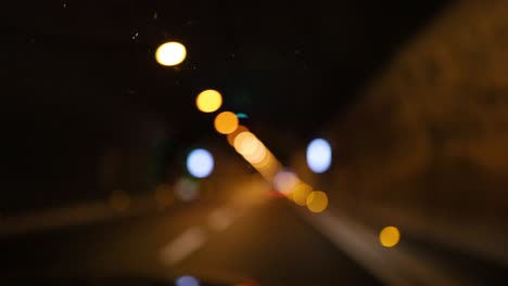 blurred lights and tunnel during night drive