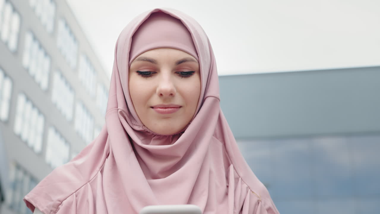 Woman in Hijab Using Phone
