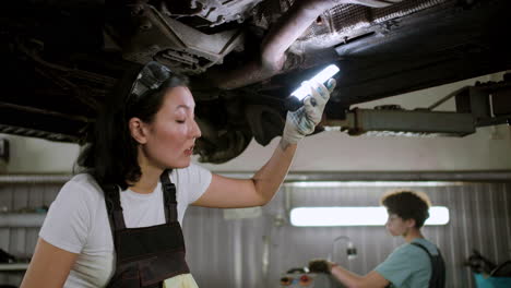 woman inspecting automobile