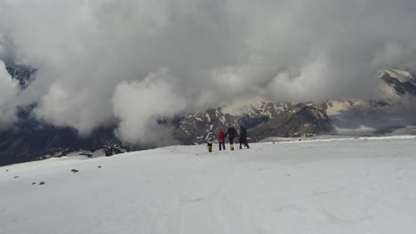 hikers on a snowy mountain peak