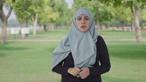 muslim woman getting a shocking news in park