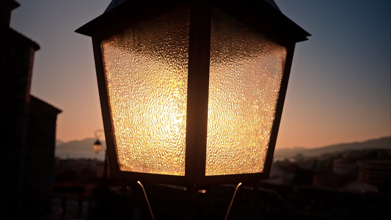 Close up of a street lamp with a blurry city view of Monaco