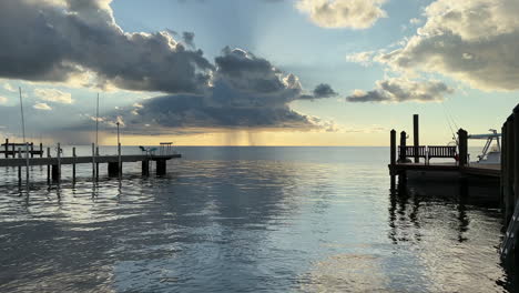 rain storm on sunny cloudy day, view from ocean pier, florida keys