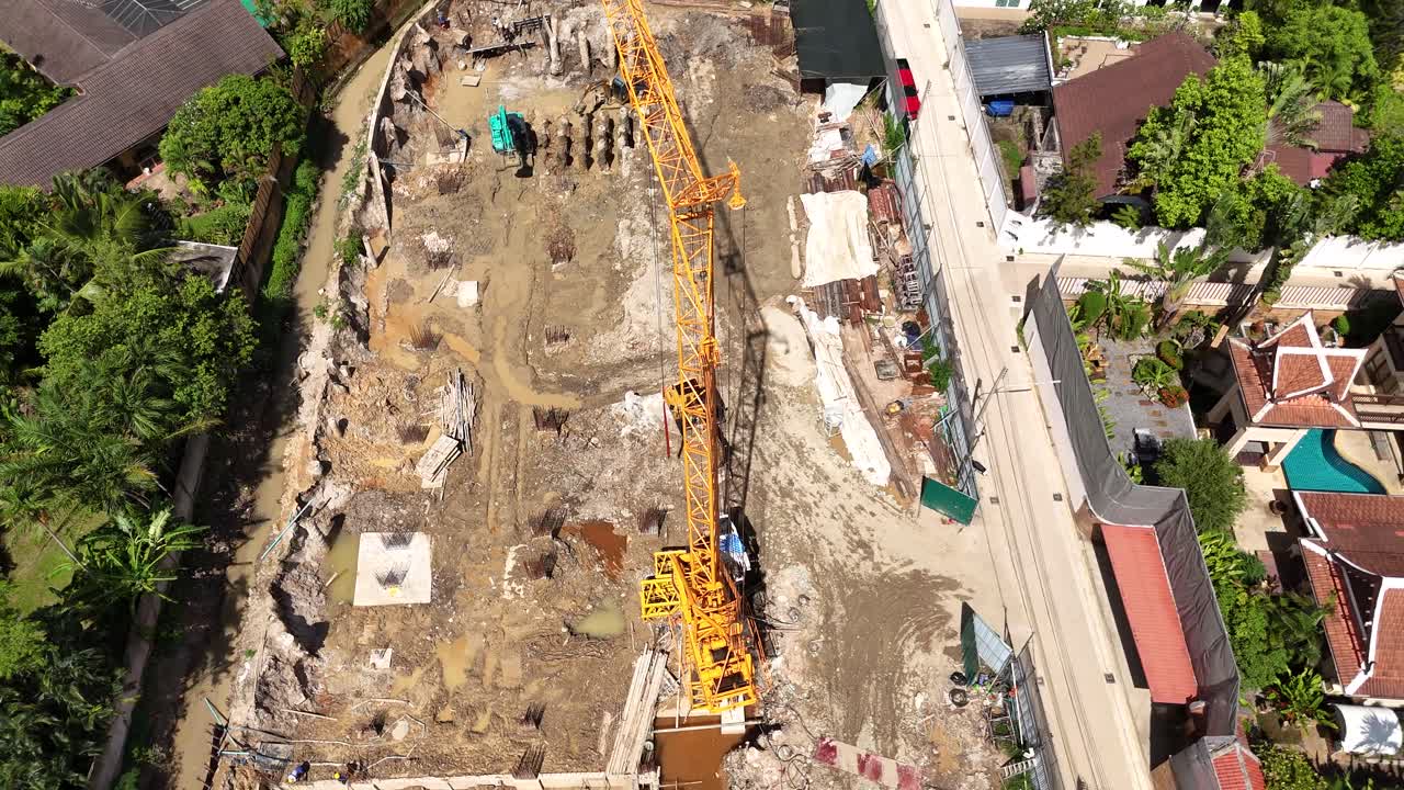 Aerial View of a Construction Site with a Large Yellow Crane