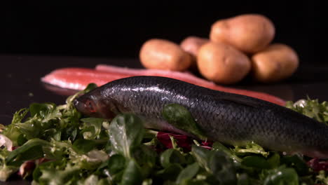 fresh whole trout falling on a bed of leaves