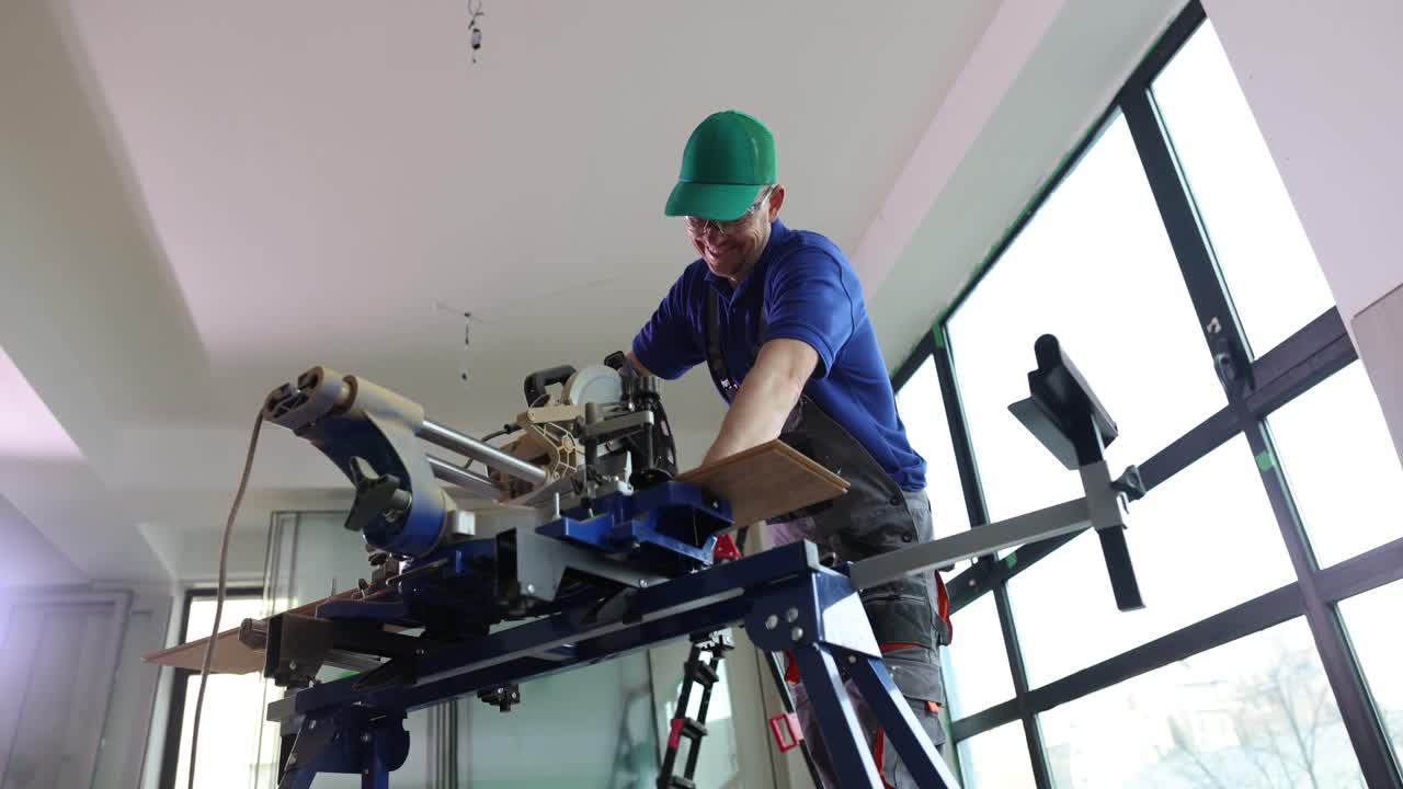 Carpenter using a miter saw to cut wood