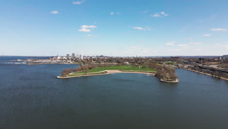 Approaching Bayfront Park On Burlington Bay In Hamilton, Ontario, Canada. Cityscape And Marina In Background. wide drone shot