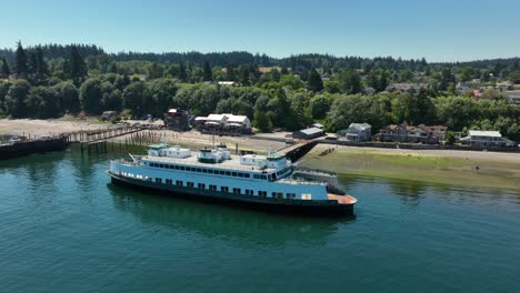 aerial view of a small seafaring ferry moored on the shore of langley, washington