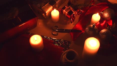 Christmas-background-with-candles,-gifts-and-wrapping-equipment