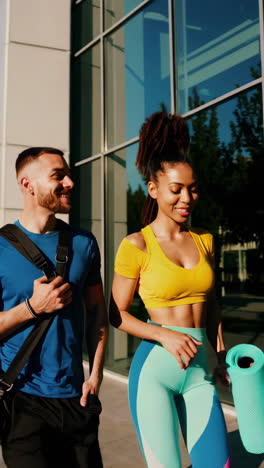 happy fitness couple walking outdoors after workout