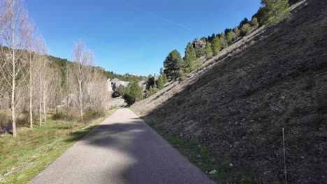 pov driving along a narrow mountain road next to a river in soria, spain