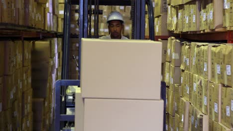 forklift driver picking up palette of boxes