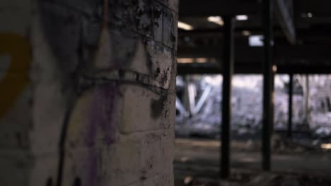 derelict urban building with graffiti wall panning shot