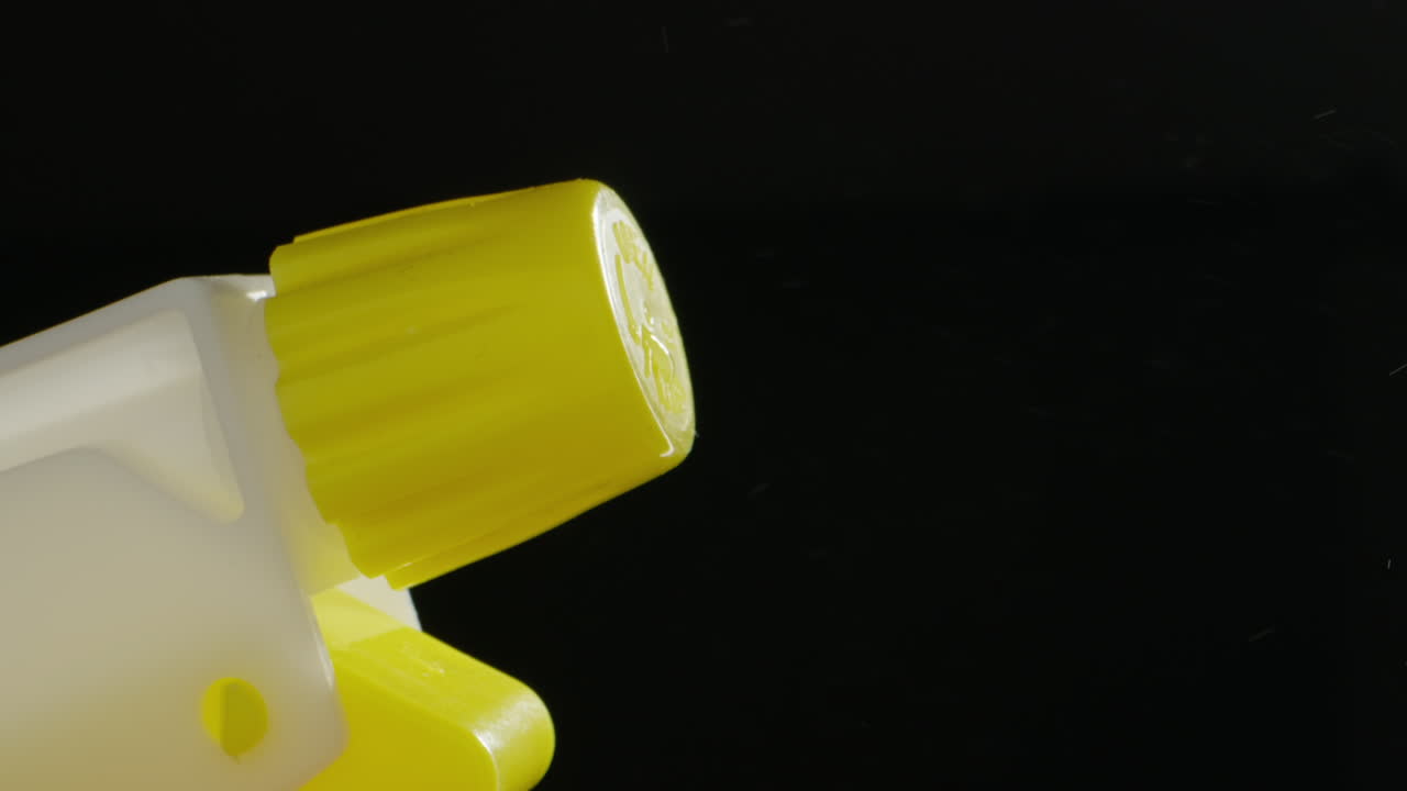 Young man applying perfume to skin in the dark, close up of spraying deodorant luxury perfume.
