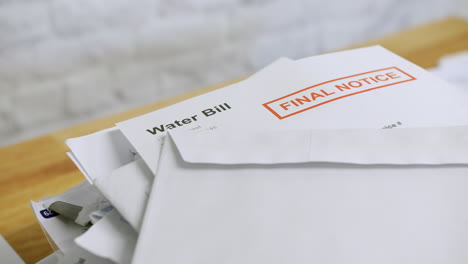 close up of a pile of bills and letters with a final notice for a water bill during a cost of living crisis