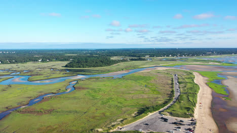 Cape-Cod-Aerial-Drone-Footage-of-Marsh-and-Beach-at-Low-Tide-with-People-and-Tall-Green-Grass