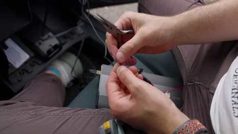 close-up-of-an-individual's-hands,-intricately-handling-small-electronic-components,-highlighting-the-focus-and-precision-required-in-such-tasks