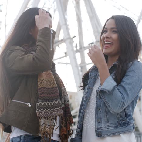 fun happy young women in front of a ferris wheel