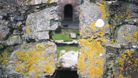 Focus-pull-shot-of-an-ancient-monastery-shot-between-two-stone-walls