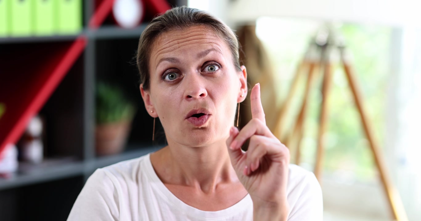 A woman sitting in the office thinks a closeup