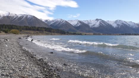 shoreline and mountain ranges in lake ohau, mackenzie basin, south island, new zealand - wide shot