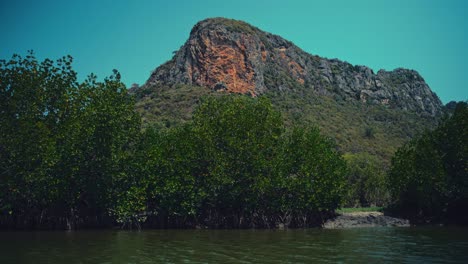 a limestone hill with a river in front in thailand