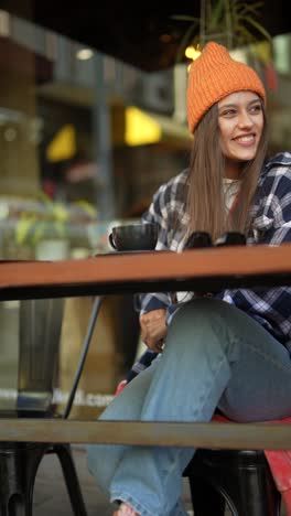 woman using phone in cafe