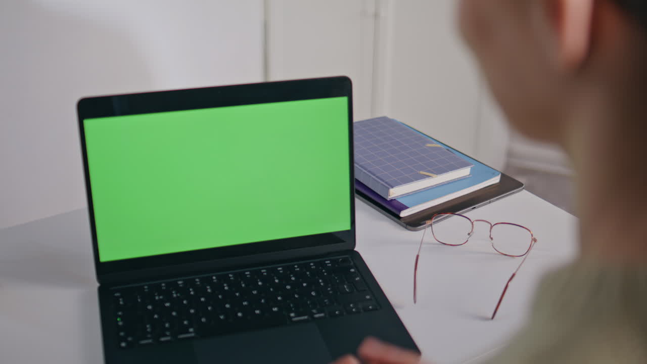 Unknown businesswoman using mockup laptop for video conference at office closeup