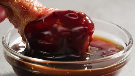 chicken wings dipping in sauce