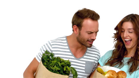 happy couple holding grocery bags