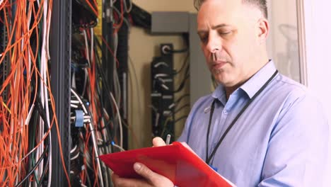 technician looking at open server locker