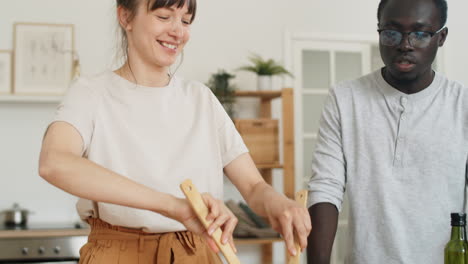 Diverse-Couple-Preparing-Salad-in-Kitchen