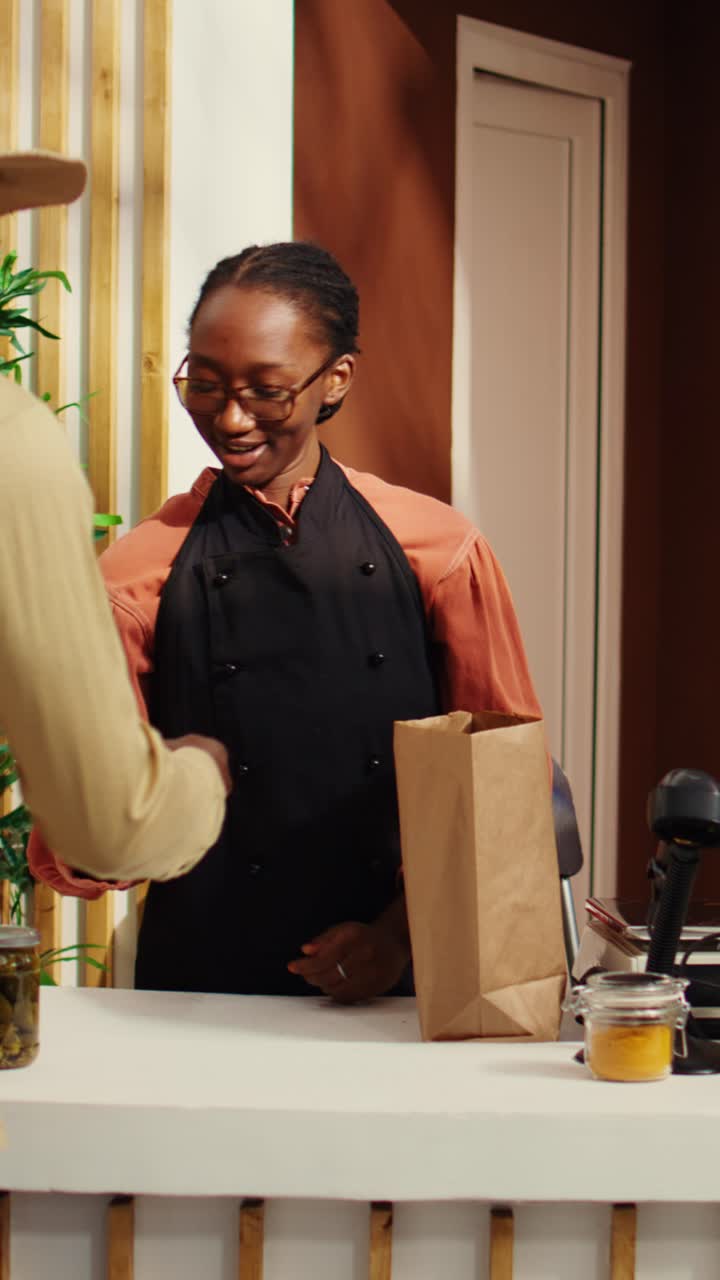 Vertical Video Vegan client buying ethically sourced fruits and vegetables at pos
