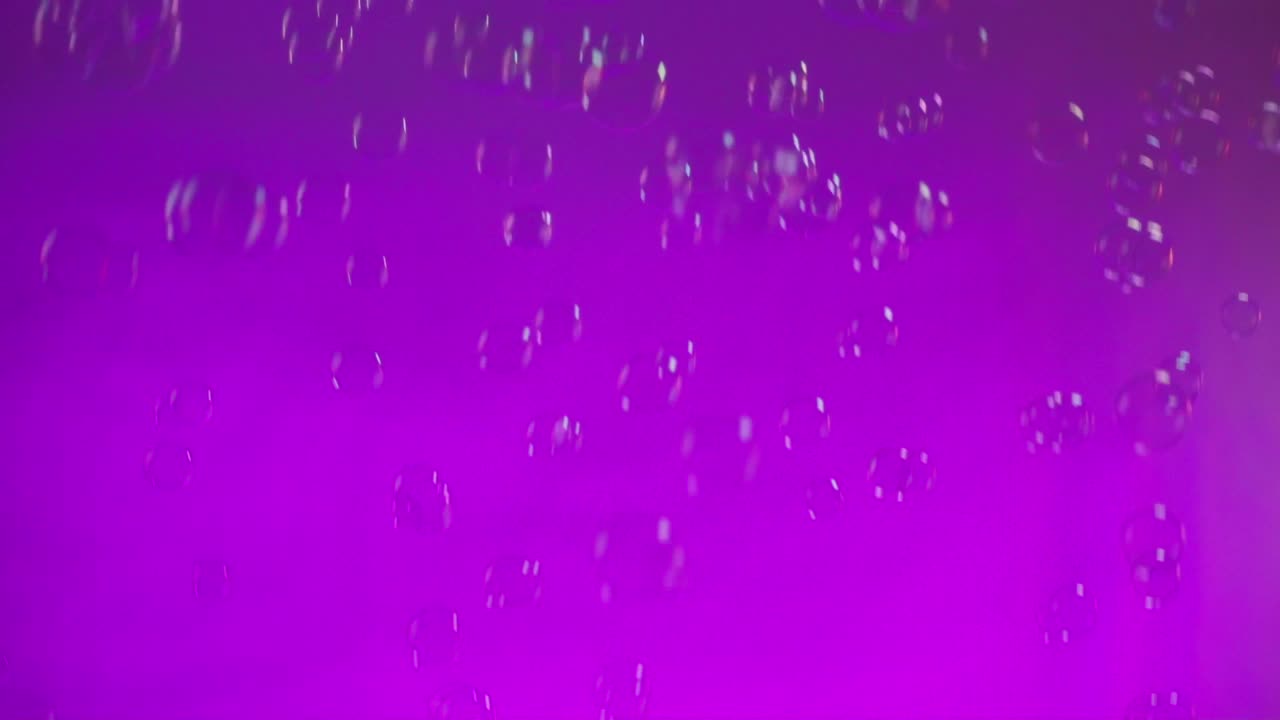 Bubbles floating in a vibrant purple background, creating a dreamy and surreal effect